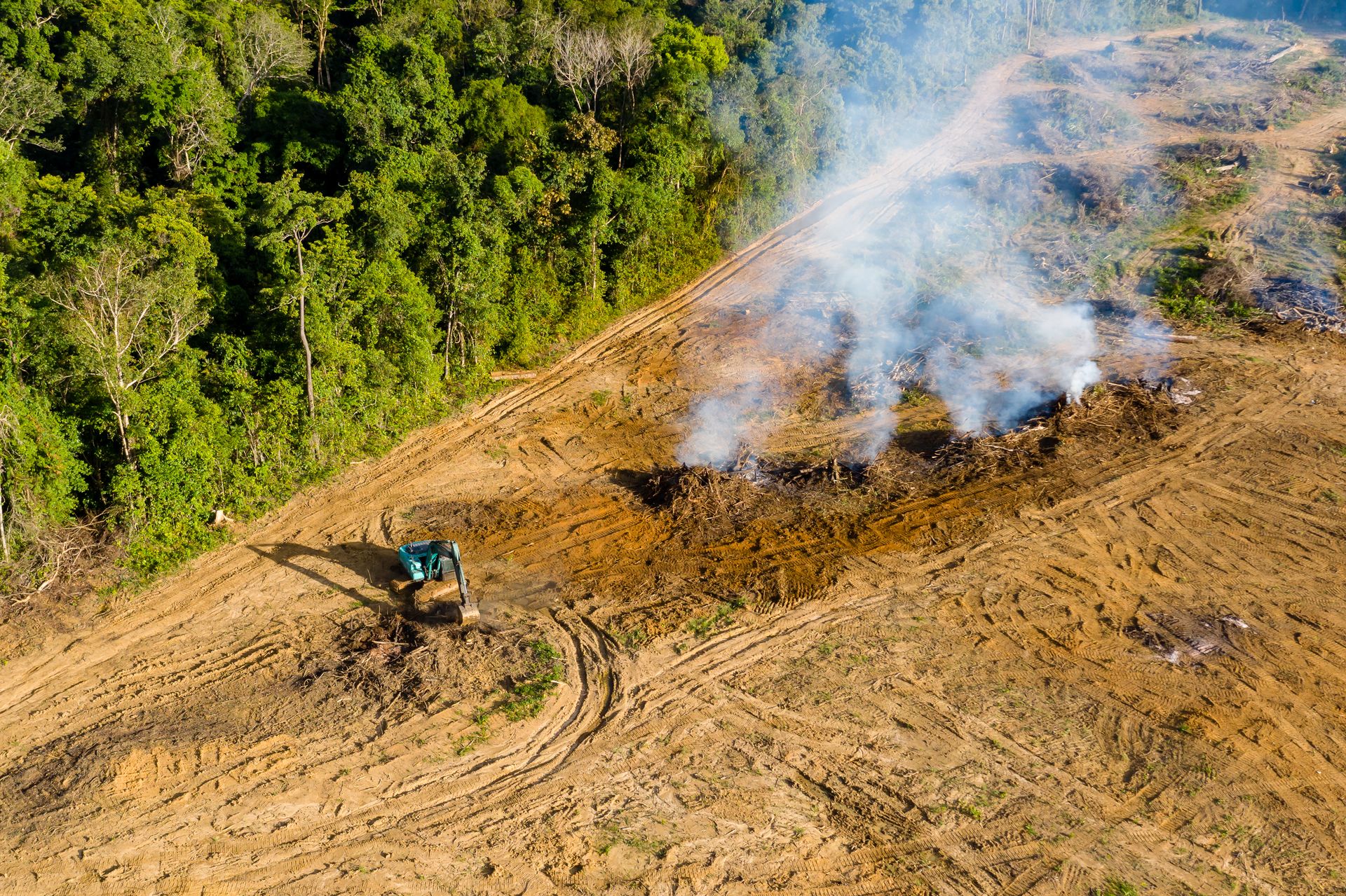 Aerial view of a land clearing project with burn piles