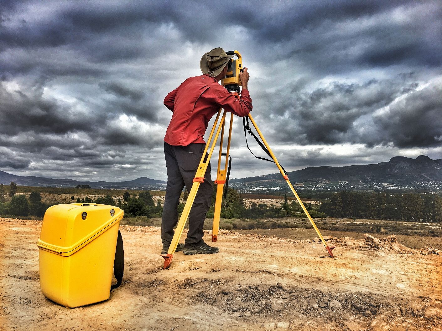 Surveyor checking elevation and layout before grading