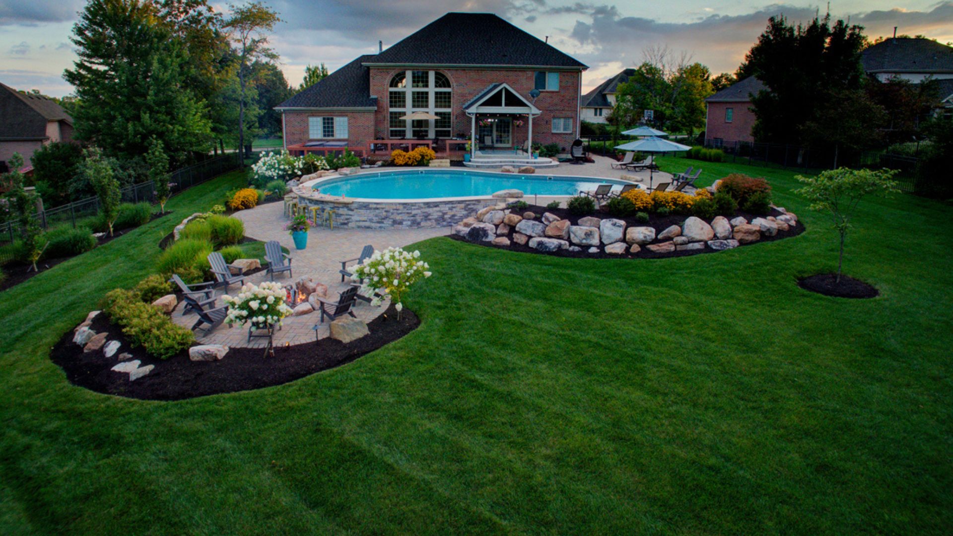 Backyard with pool and landscape lighting