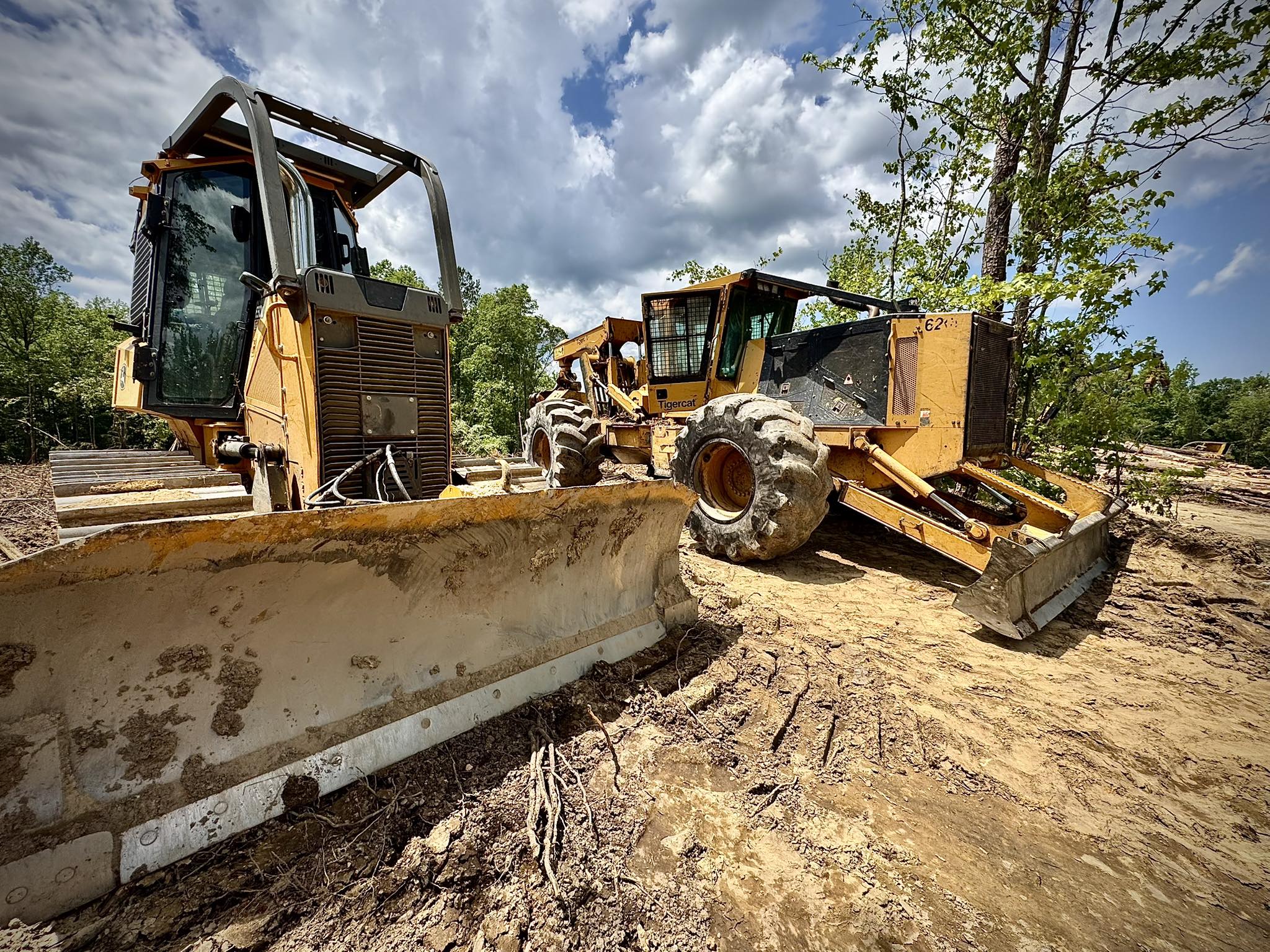 Skidders and dozers staged on a logging site